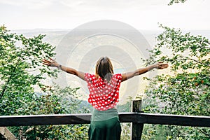 Young female nature explorer enjoying the view from viewpoint