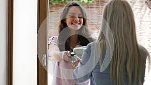 Young Female Neighbor Helping Senior Woman