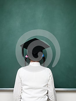 Young female nerd looking into blackboard