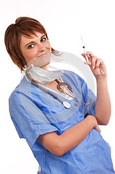 Young female nurse holding filled syringe