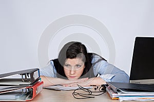 Young female office worker at desk