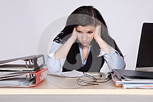 Young female office worker at desk