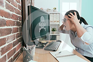 Young female office worker using computer working