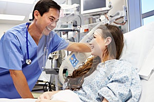 Young Female Patient Talking To Male Nurse In Emergency Room photo