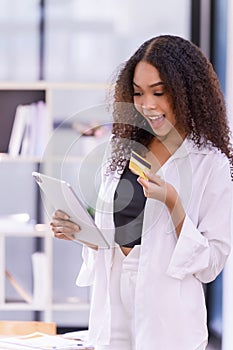 A young female paying her bills by a mobile banking payment application, using a mobile banking app or online shopping app