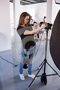 Young female photographer work in studio