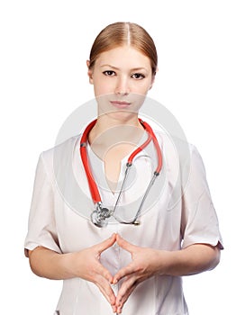 Young female physician in doctor's smock with stethoscope