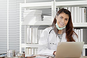 Young female physician wear white coat with stethoscope using laptop while working at examination room, healthcare and medical