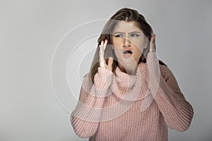Young Female in Pink Sweater Looking Worried