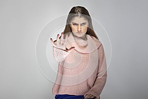 Young Female in Pink Sweater With Stop Gesture