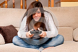 Young female playing video-games home