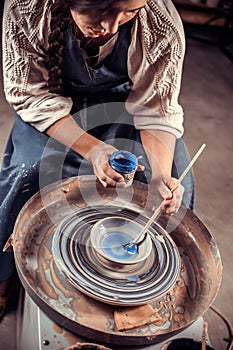 Young female potter working on a potter& x27;s wheel