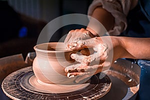 Young female potter working on a potter& x27;s wheel