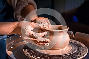 Young female potter working on a potter& x27;s wheel
