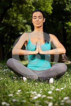 Young female practicing yoga in nature