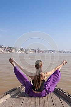 Young female practising yoga posture Upavishta konasana