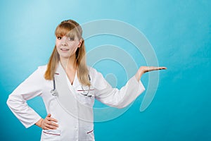 Young female professional doctor showing copy space