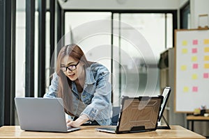 Young female programmer working on laptops.