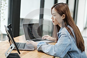 Young female programmer working on laptops.