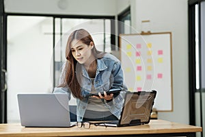 Young female programmer working on laptops.