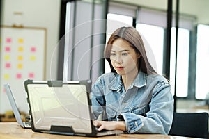 Young female programmer working on laptops.
