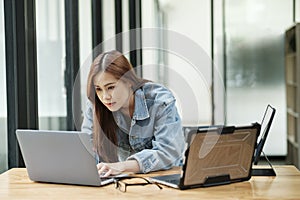 Young female programmer working on laptops.