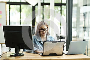 Young female programmer working on laptops.