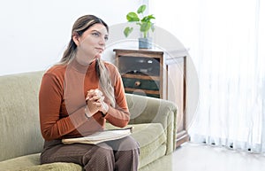 Young female psychologist listening attentively to a patient during therapy sitting in an armchair in her office