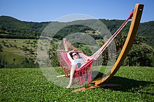 Young female relaxing in a hammock