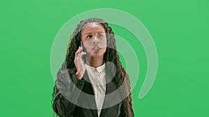 Young female reporter isolated on chroma key green screen background. African american woman tv news host walking and