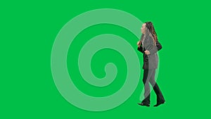 Young female reporter isolated on chroma key green screen background. Full shot african american woman tv news host