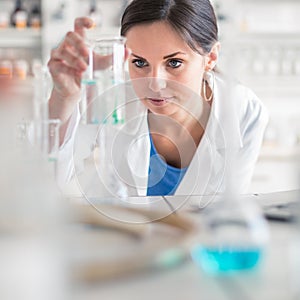 Young, female researcher carrying out experiments in a lab