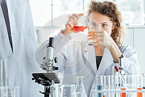 Young female researcher working in modern biological laboratory