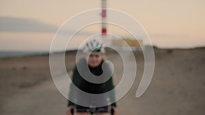 Young female road cyclist smiles and laughs