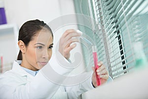 young female scientist researching in laboratory