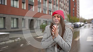 Young female sick woman, girl blowing nose to paper napkin and sneezing at street outside, healthcare, flu, people