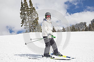 Young female skier skiing downhill at ski resort