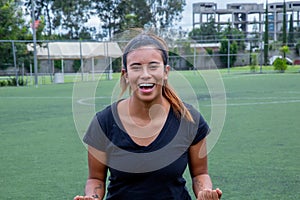 Young female soccer or football player celebrating the goal