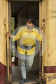 An young female solo traveler just getting down from the train of Indian Railway