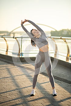 Young female sportsperson having a workout outside