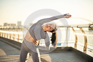 Young female sportsperson having a workout outside