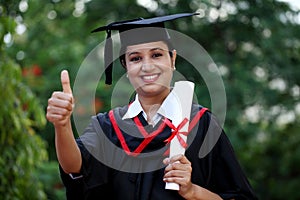 Young female student with diploma at outdoors
