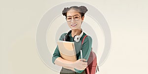 Young female student happy carries notebook and pen against white background