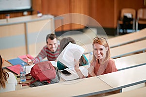 Young female student happy about her scores of the exam photo