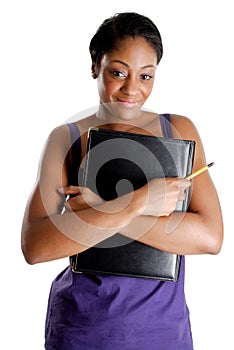 Young female student holding pencil and book