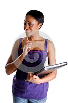 Young female student holding pencil and book