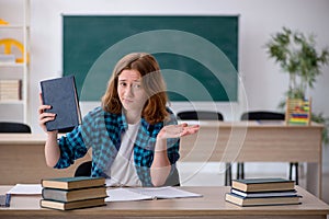 Young female student preparing for exam in the classroom