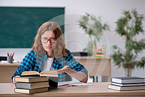 Young female student preparing for exam in the classroom