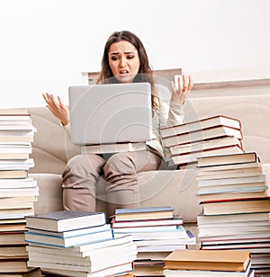 Young female student preparing for exams at home