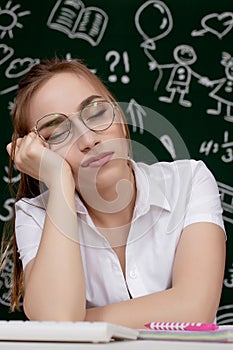 Young female student sleeping in a classroom